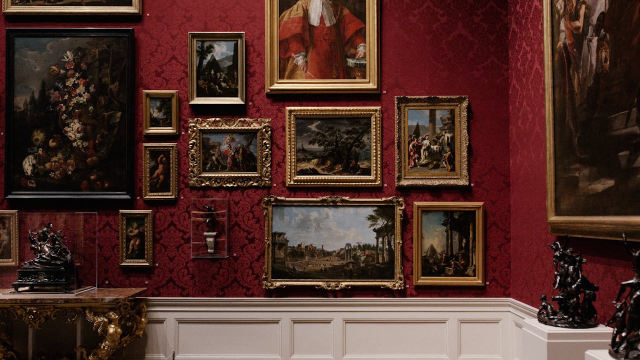 Art gallery with classical paintings on ornate red walls