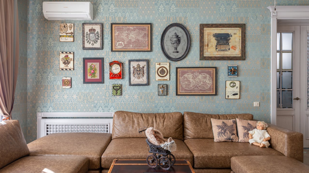 Art prints arranged on a living room wall in a gallery layout