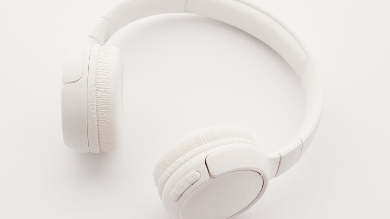 Business professional wearing noise-canceling headphones in office