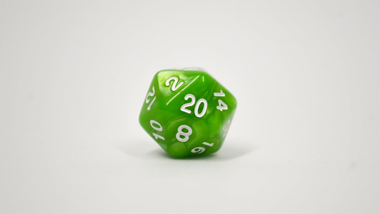 Polyhedral gaming dice in emerald green showing d20 and supporting dice