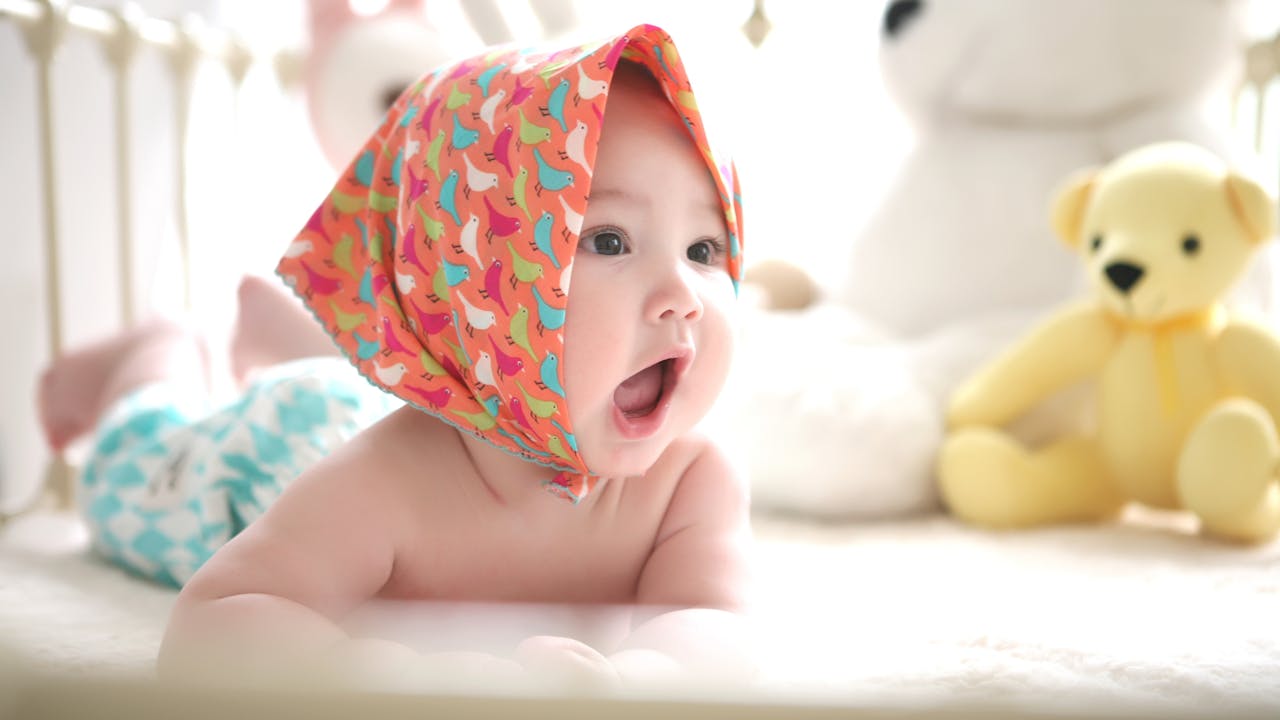 Newborn baby sleeping peacefully wrapped in soft white blanket