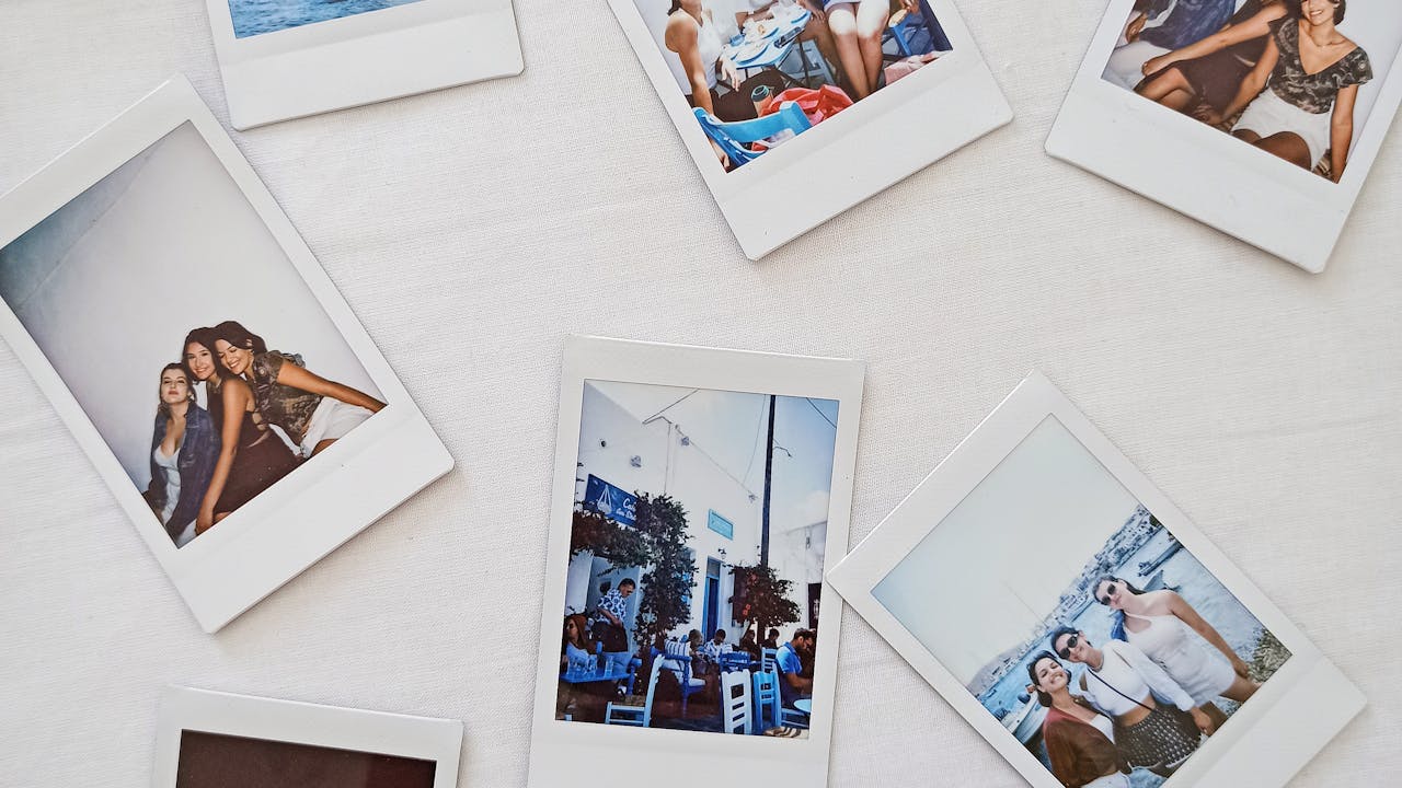 Polaroid photos spread out on a table showing family memories