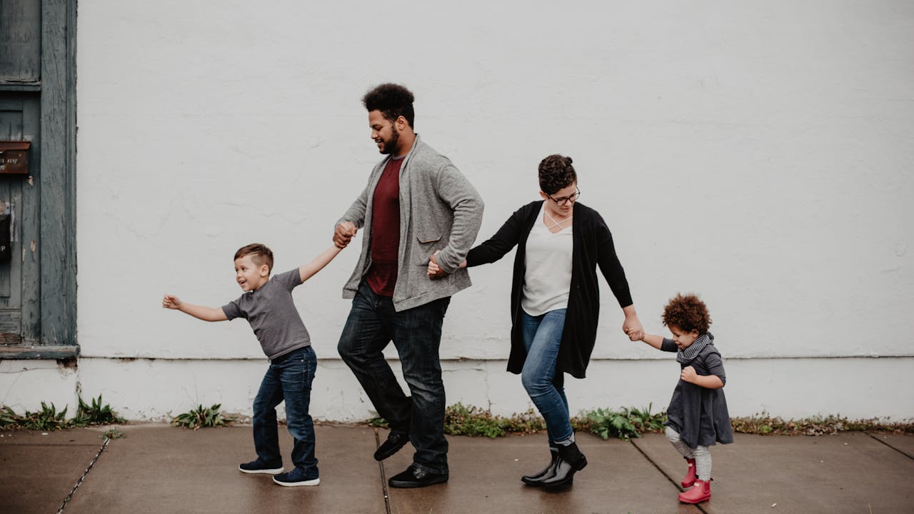 A family wearing coordinated earthy tones in a natural outdoor setting