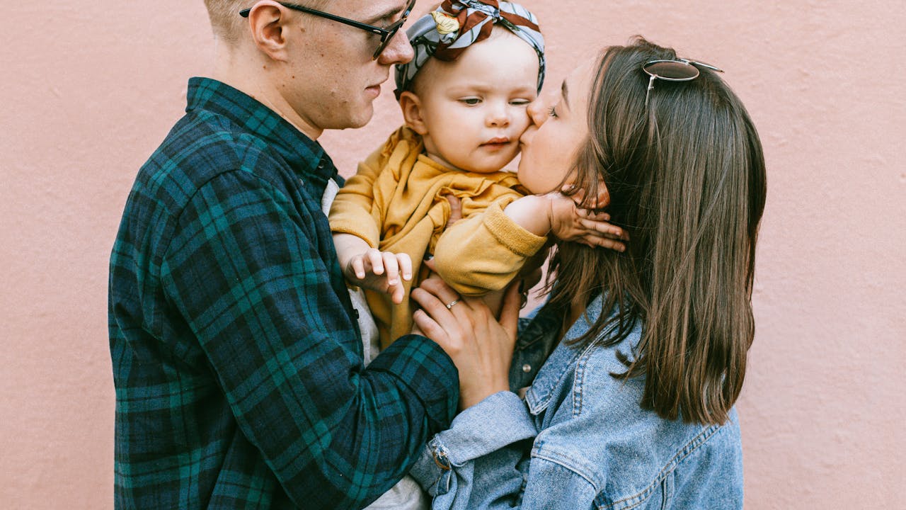 Family in coordinated winter outfits in a snowy outdoor setting
