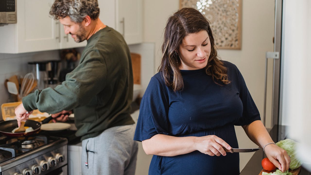 Couple cooking together in a bright kitchen