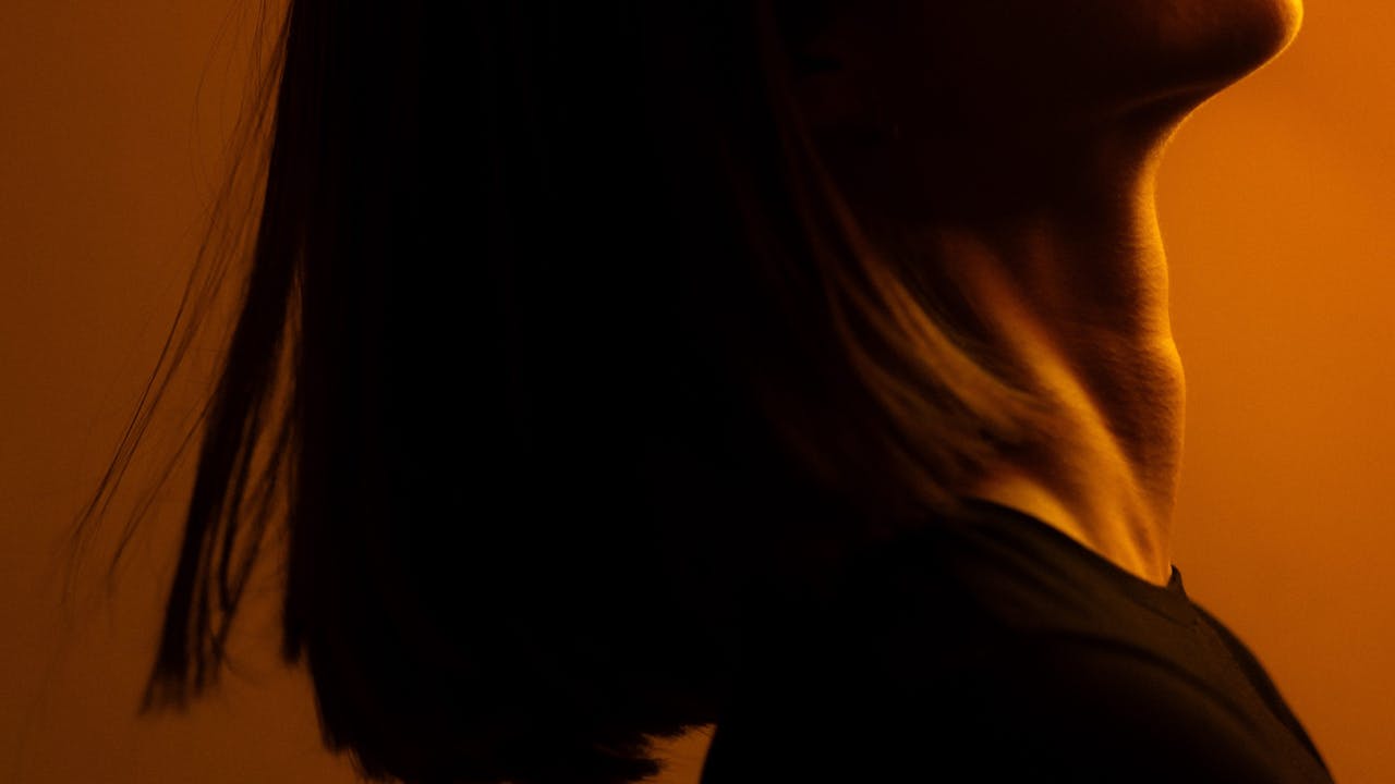 Elegant side-profile portrait in warm golden light, artistic and intimate