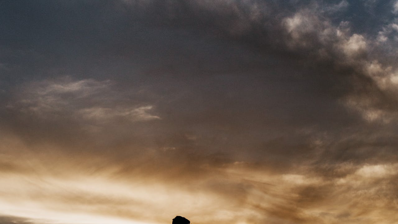 Silhouette portrait of couple against a glowing sunset sky