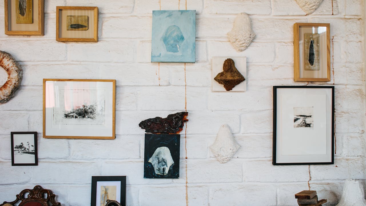 Gallery wall with framed portrait artwork displayed on light-colored wall