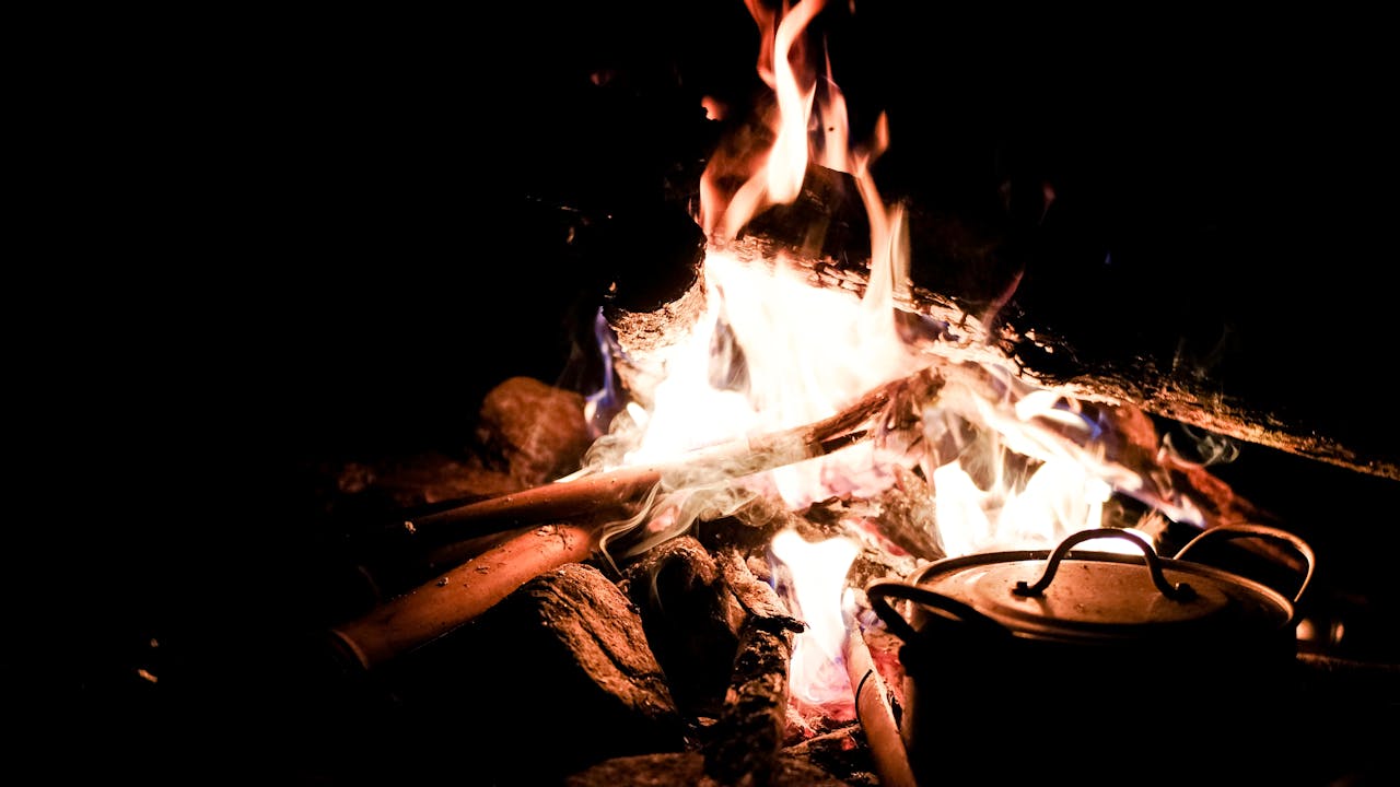 Hunting camp with campfire in the evening, autumn setting