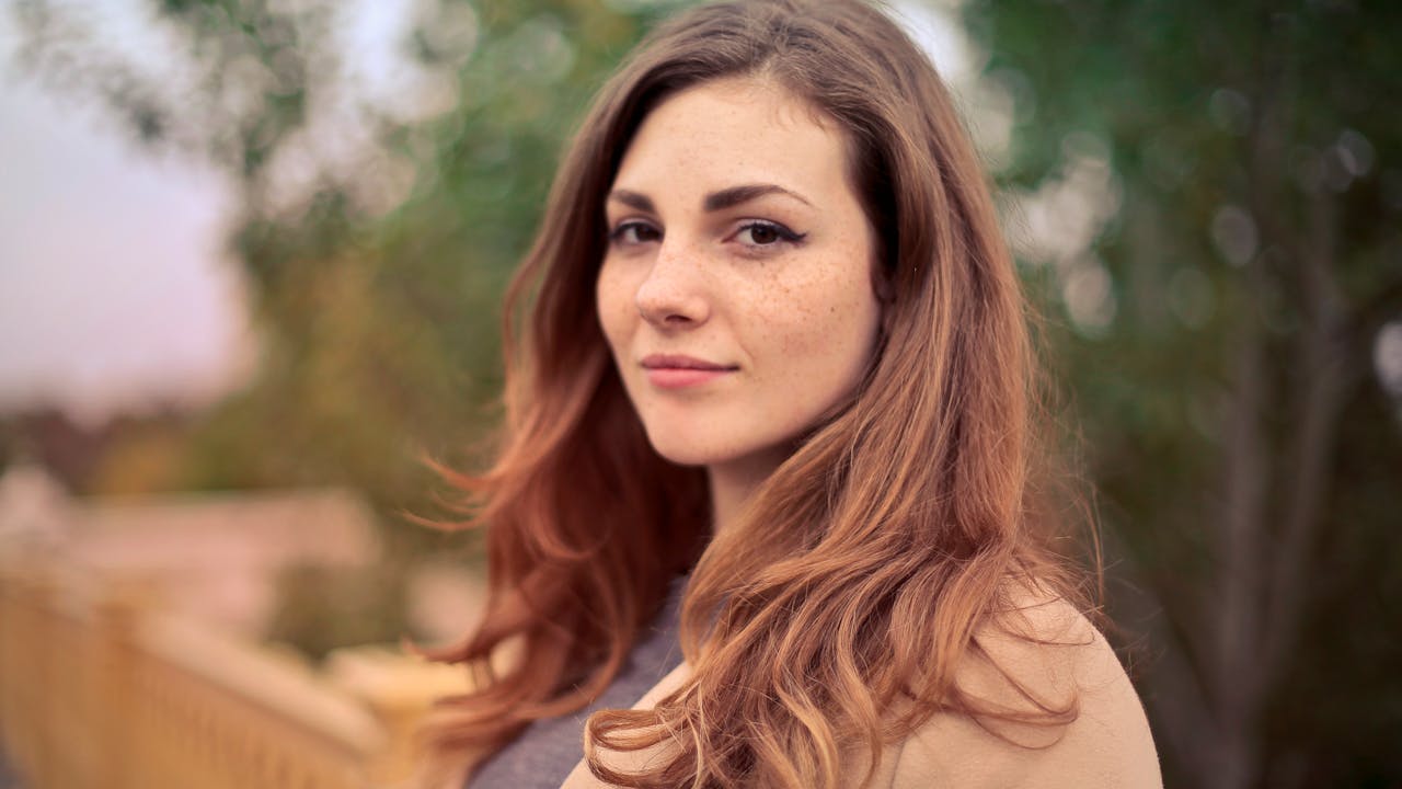 Outdoor senior portrait session with natural fall foliage background