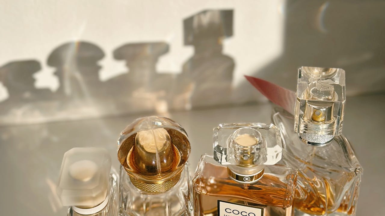 Luxury perfume and fragrance bottles in warm golden light