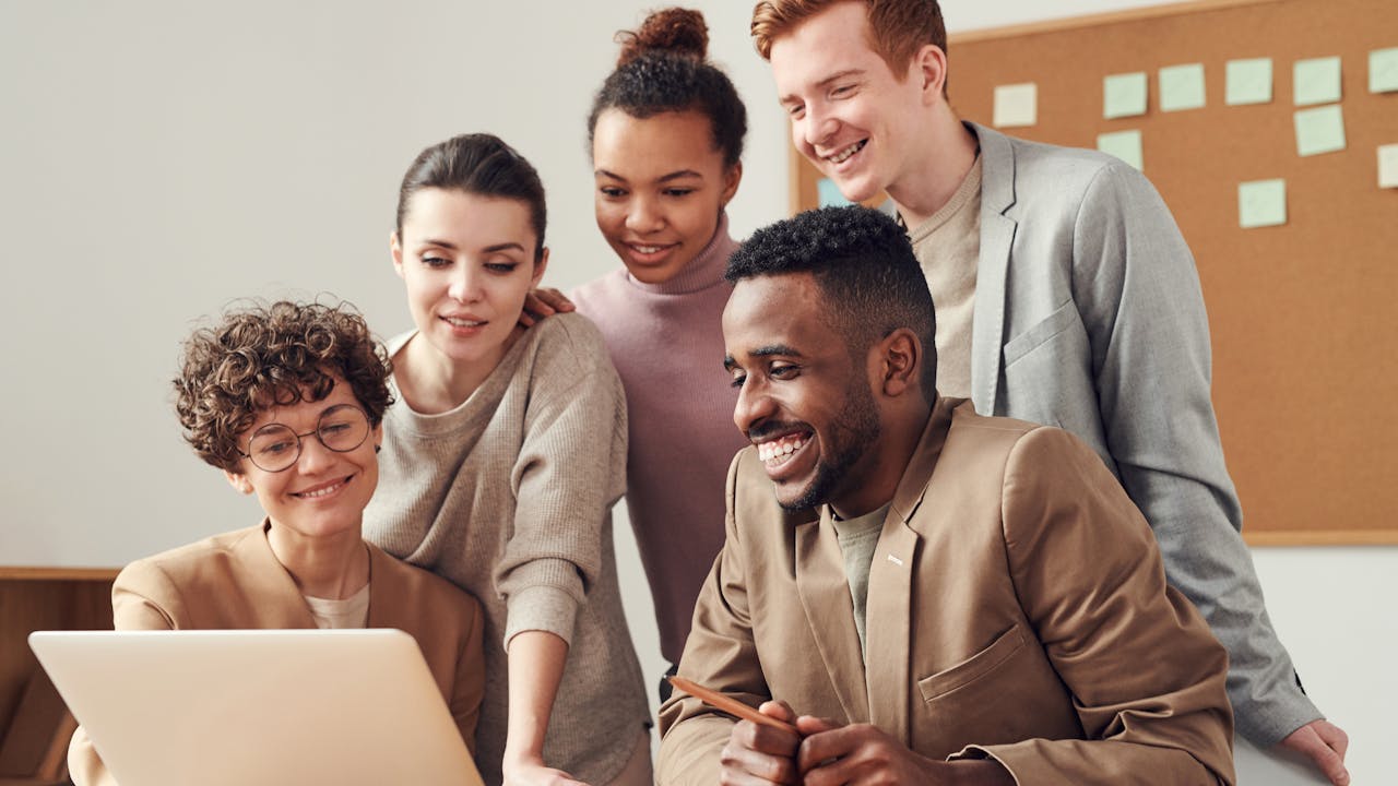 Professional team celebrating employee recognition in modern office
