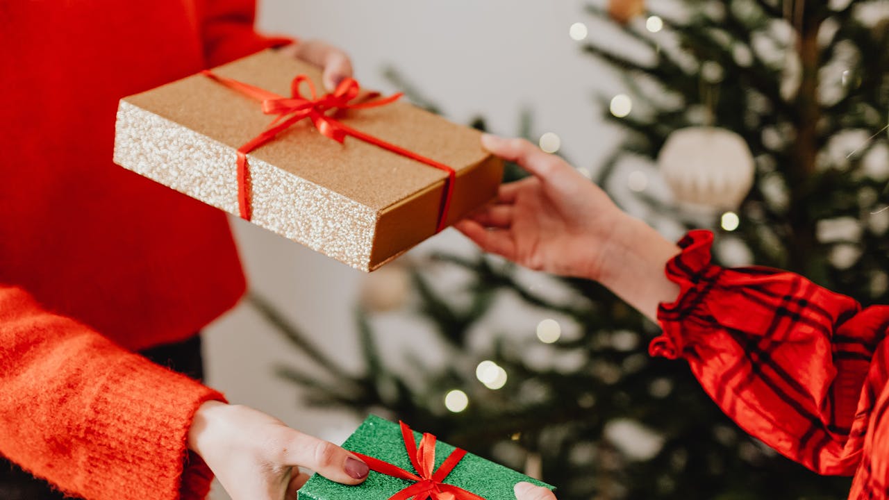 Couple sharing holiday gifts in a cozy festive setting