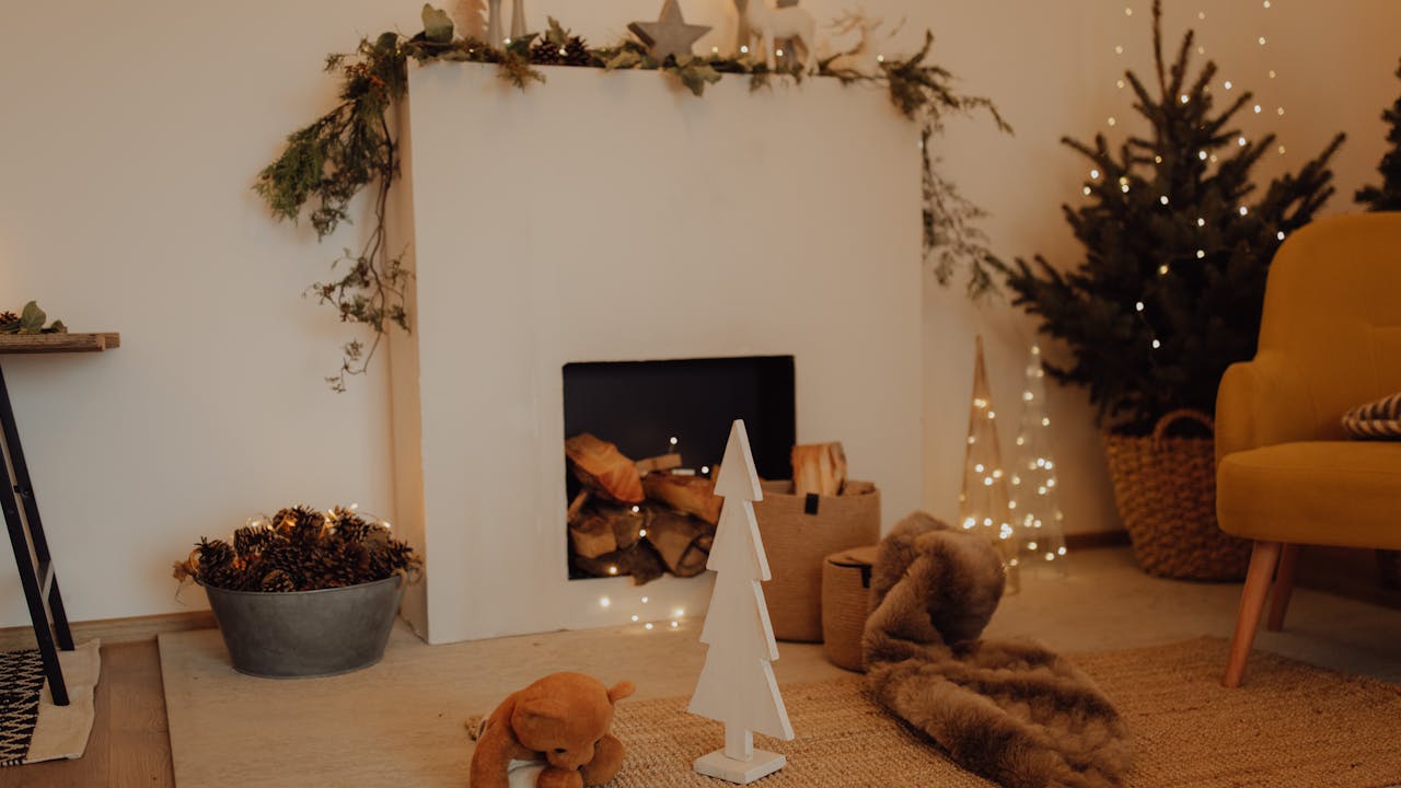 Cozy holiday scene with candles, blanket, and hot cocoa