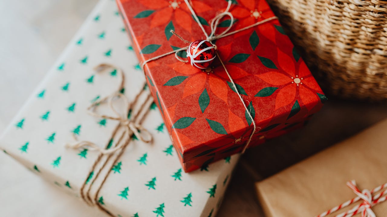 Small thoughtful gifts arranged in holiday wrapping