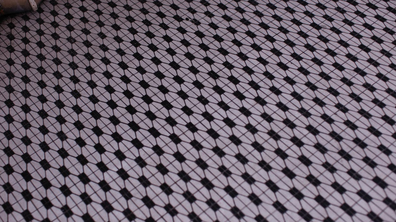 Art deco geometric pattern close-up with gold and emerald tones