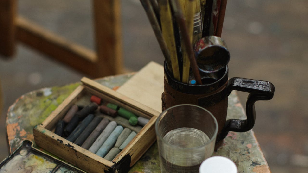 Paint brushes and art supplies in a creative studio