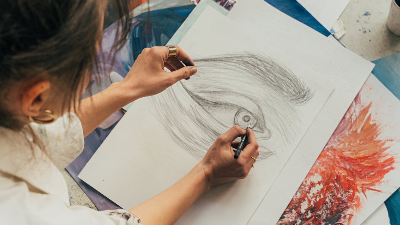 Young artist drawing while sitting on the floor