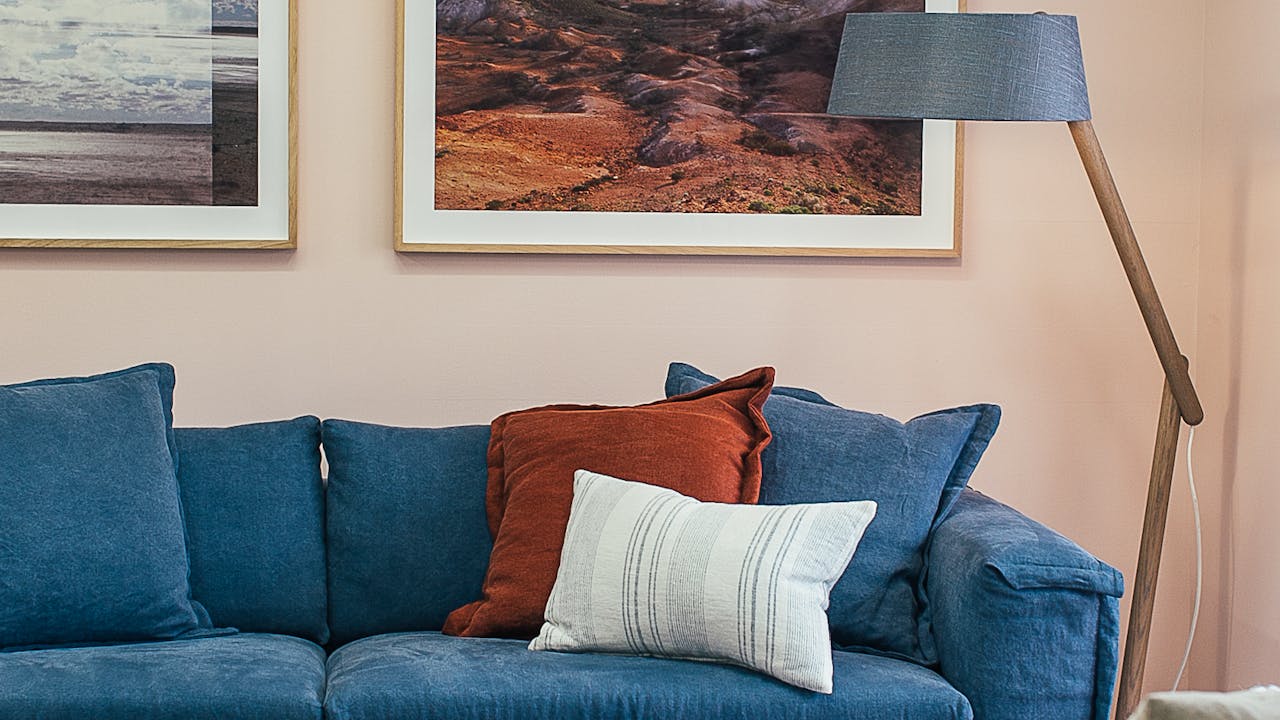 Stylish living room with wall art and comfortable decor, showing how portraits enhance a space