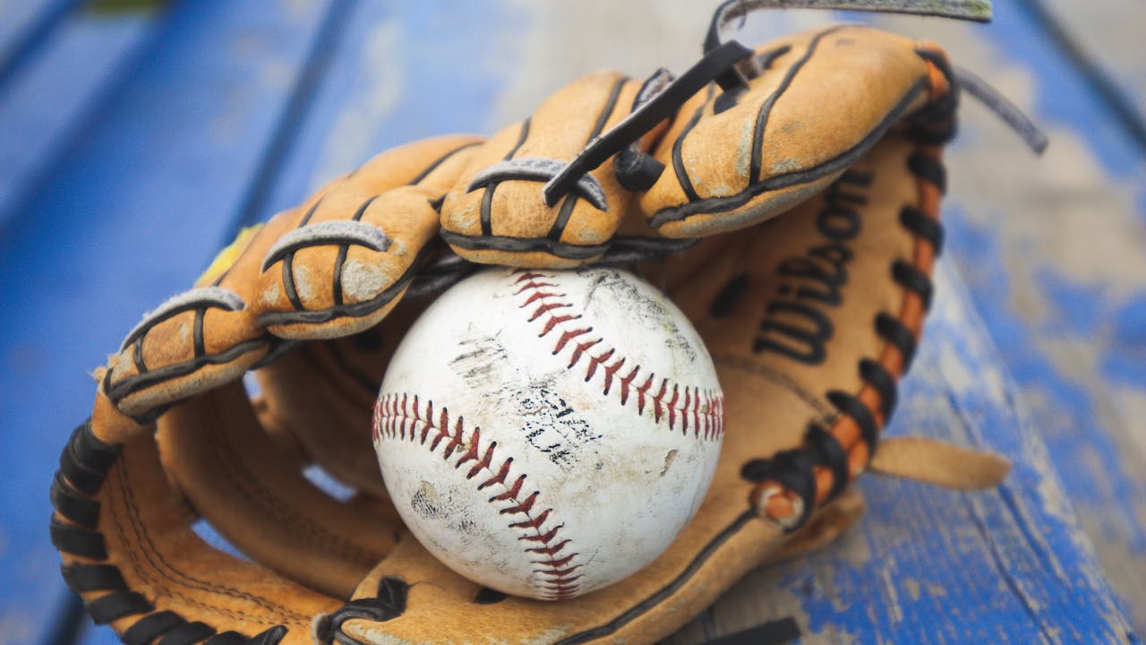 Baseball glove and ball on the field at golden hour