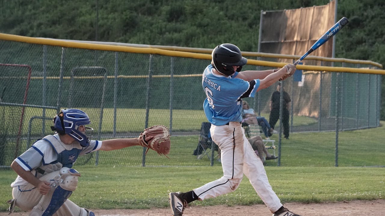 Man practicing his baseball swing outdoors