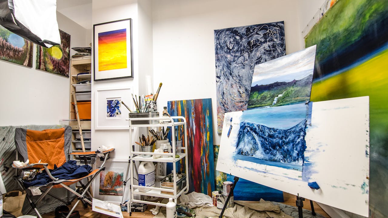 Colorful art supplies and sketchbooks on a creative workspace