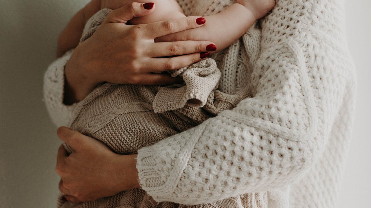 New mom tenderly holding her baby
