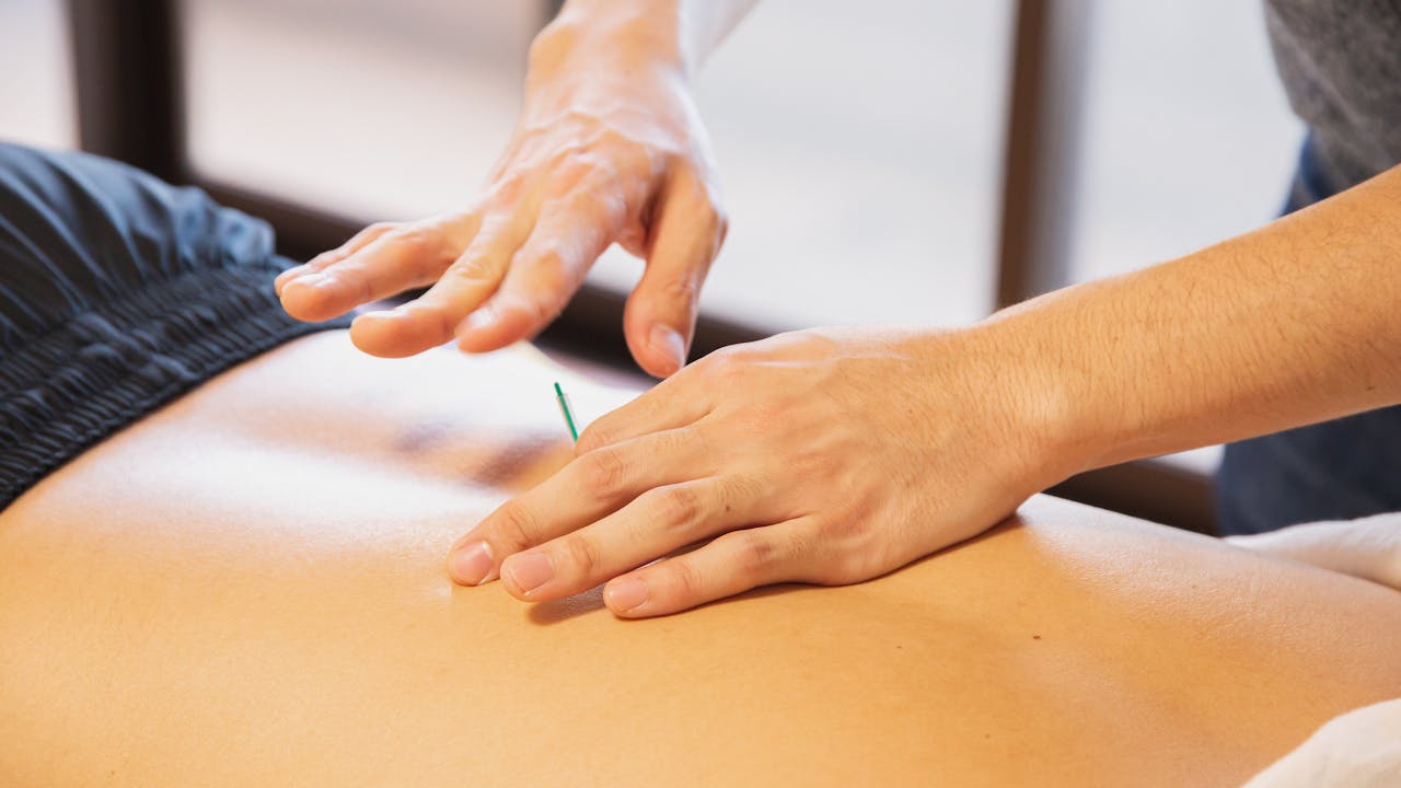 Physical therapist working with patient on rehabilitation exercises