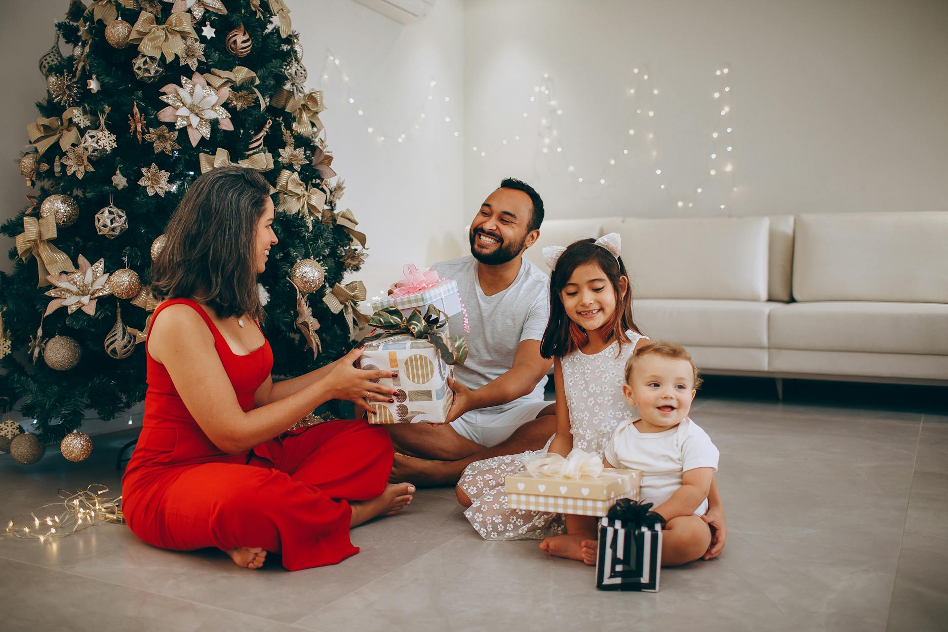 Family celebrating Christmas together with wrapped gifts, capturing the joy of holiday gift giving