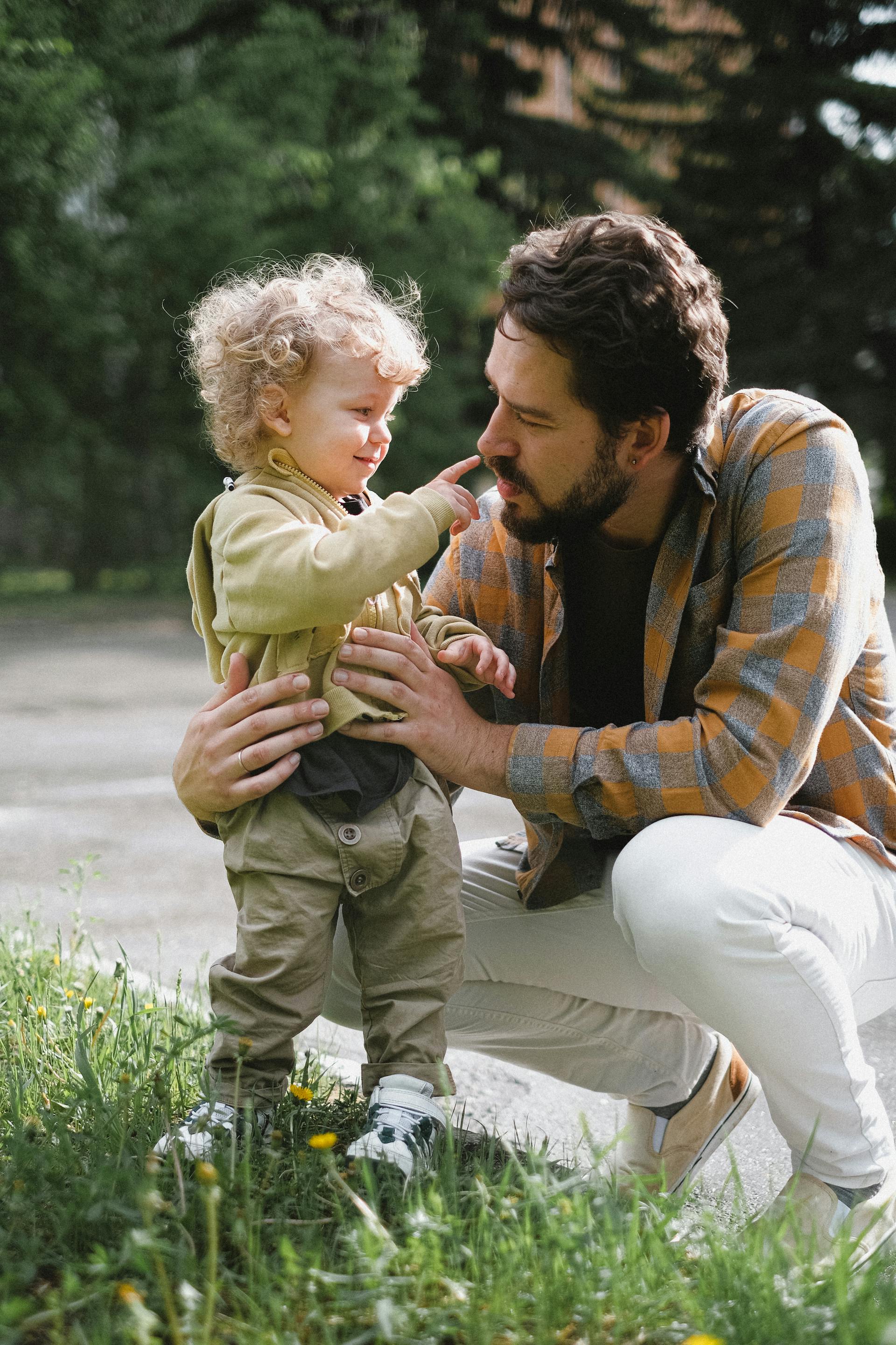 Father and son enjoying quality time together in a park, showing the special bond between parent and child