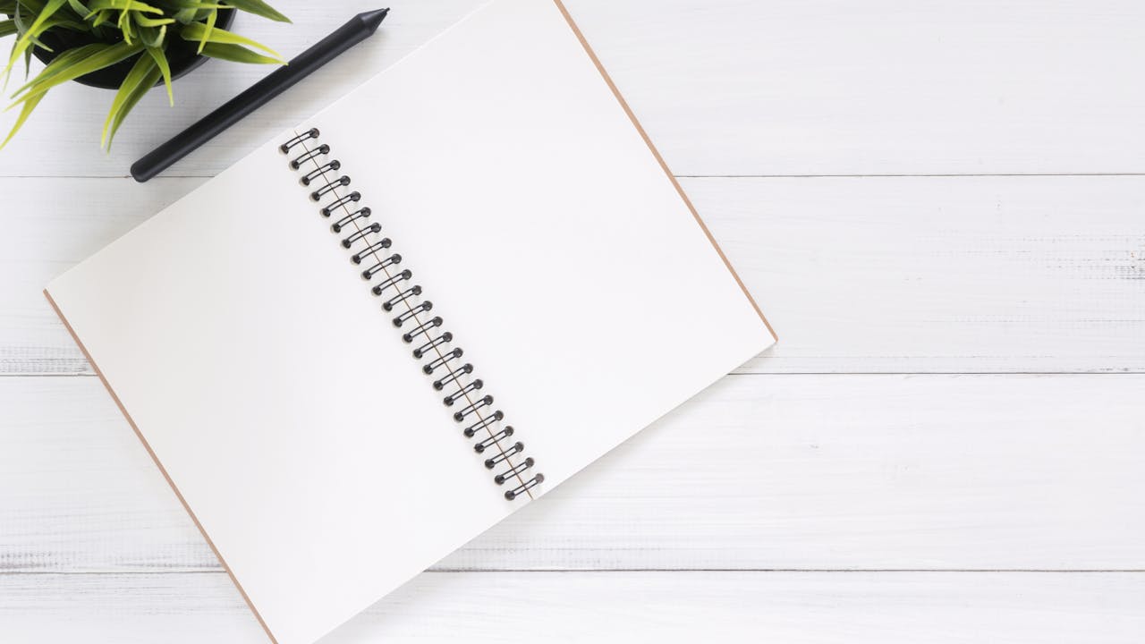 Leather journal and pen on a wooden desk