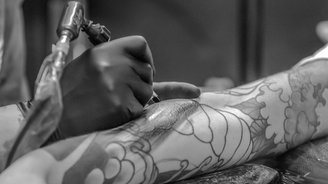 Close-up of detailed tattoo work on client's arm