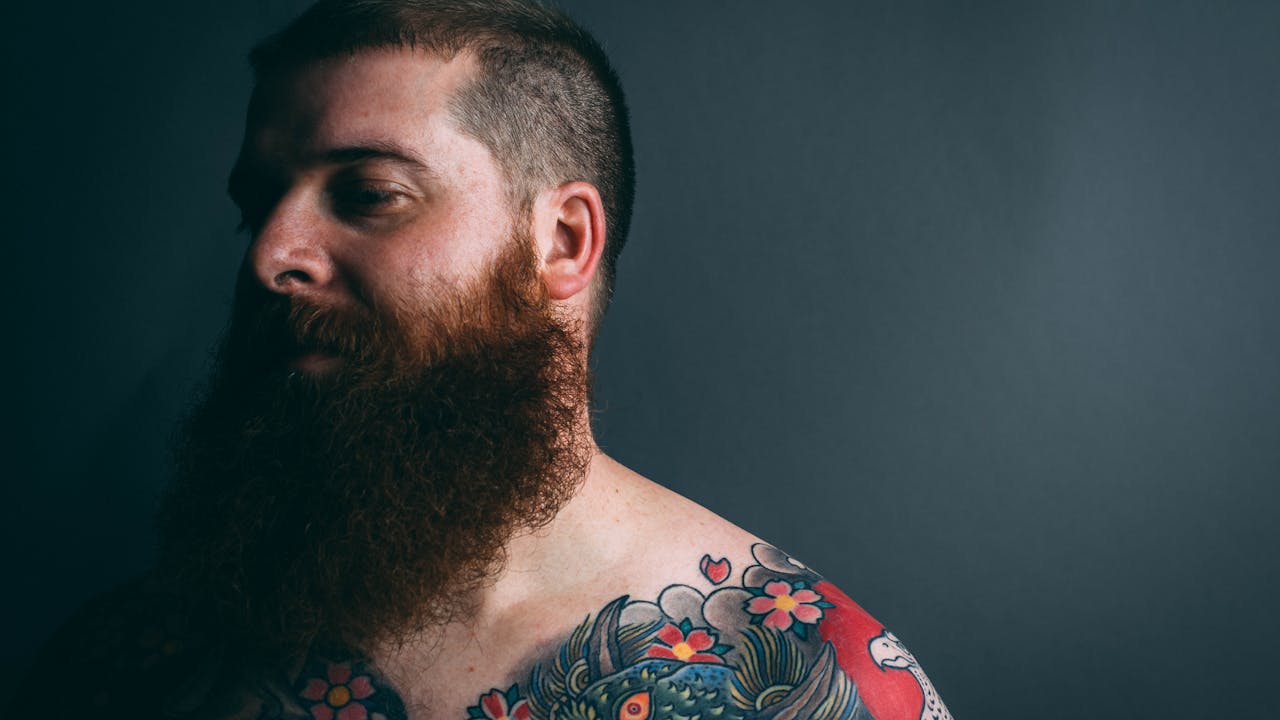 Client handing cash tip to tattoo artist after session