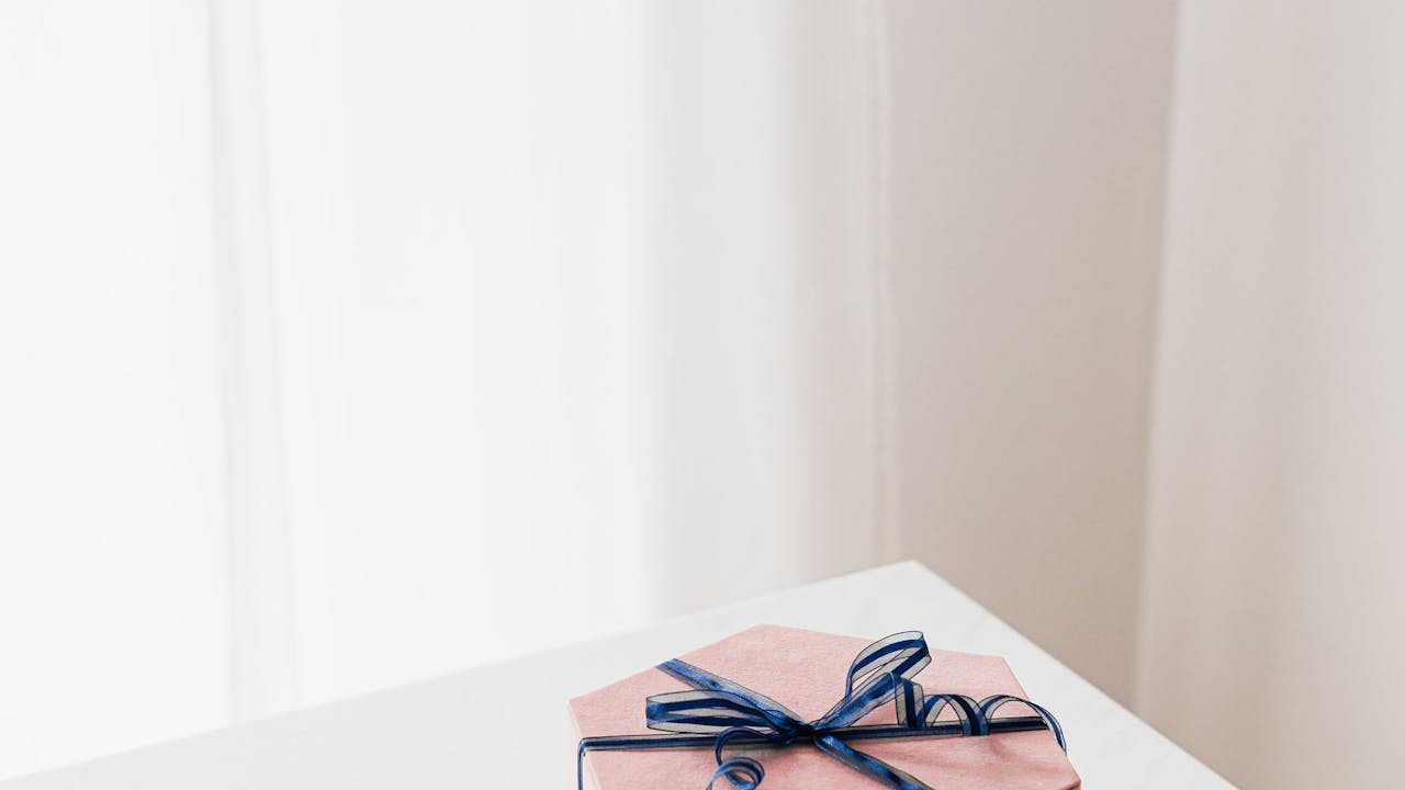 Professional gift wrapped beautifully with ribbon on a desk