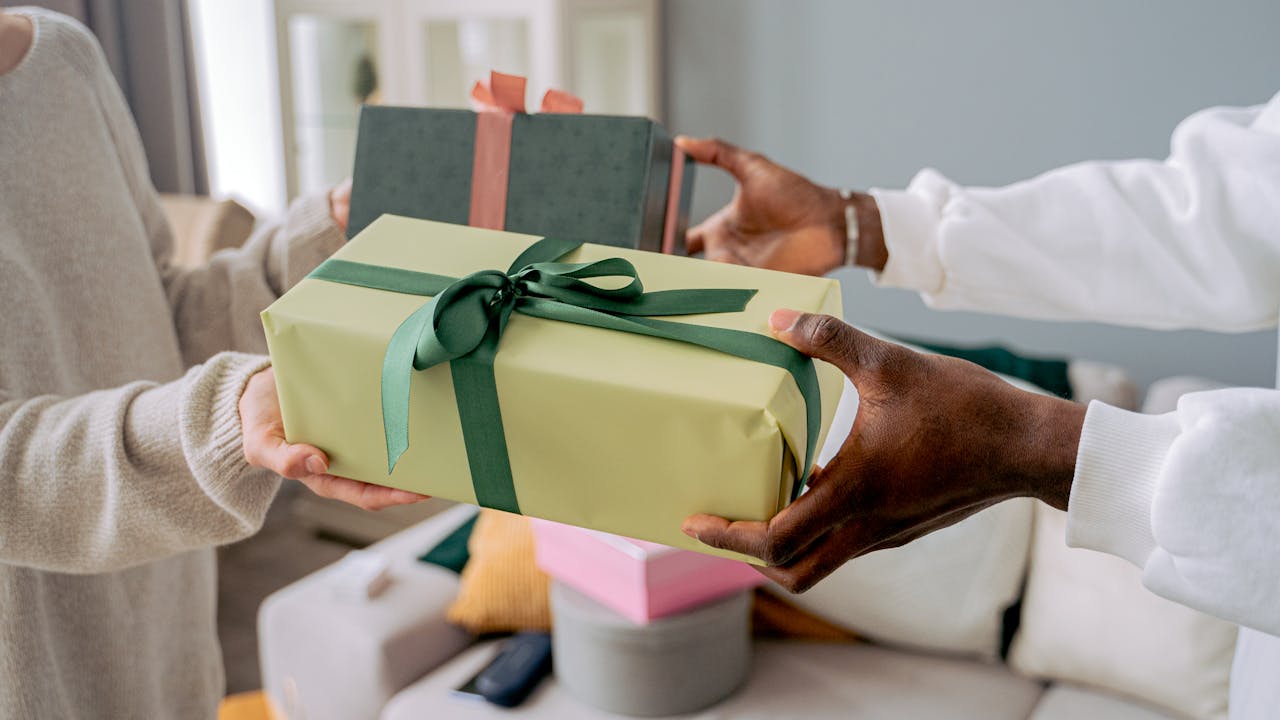 Couple sharing Valentine's Day gifts with genuine smiles