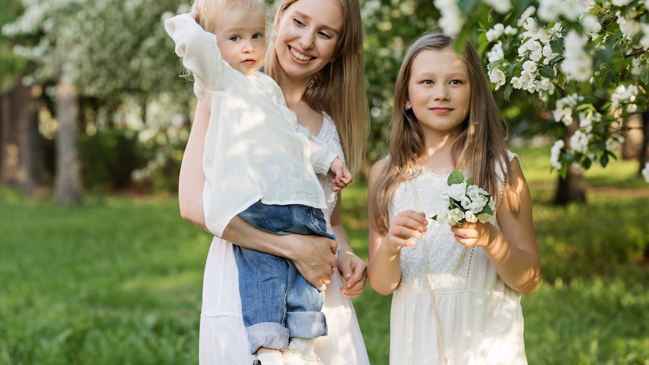 Happy family smiling together in natural outdoor portrait session in a park