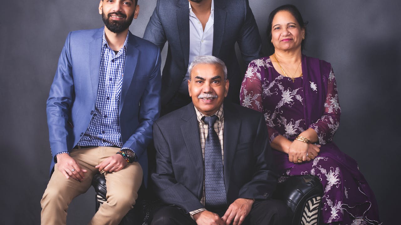 Smiling family posing together in a professional portrait photography session