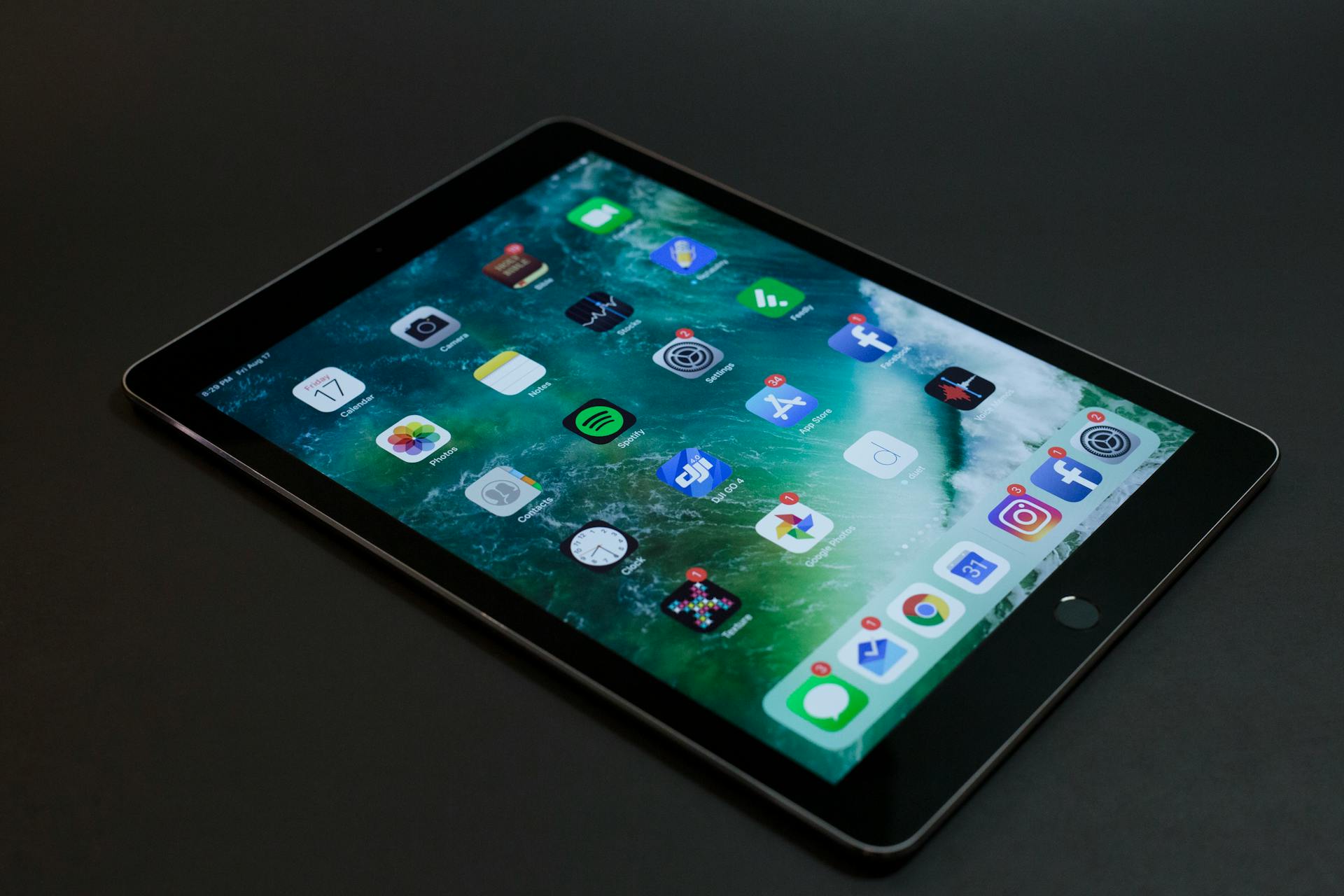 Modern tablet and wireless earbuds on desk