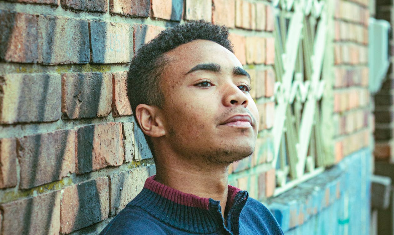 Young man in suit walking toward camera during senior portrait session