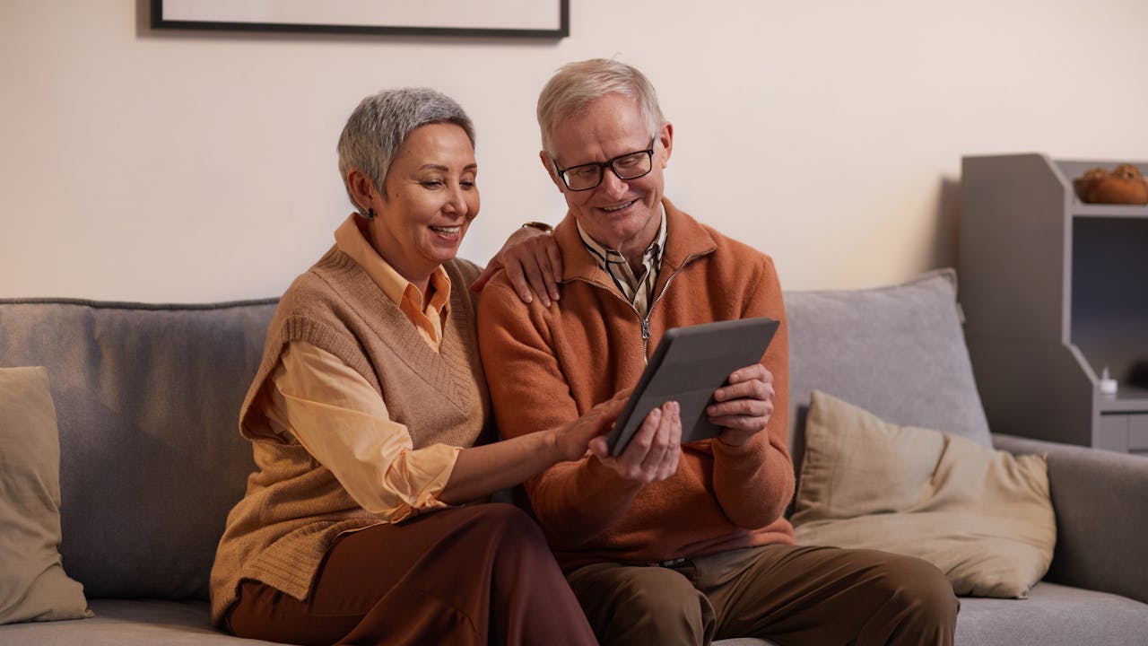 Couple reviewing photos together on a tablet